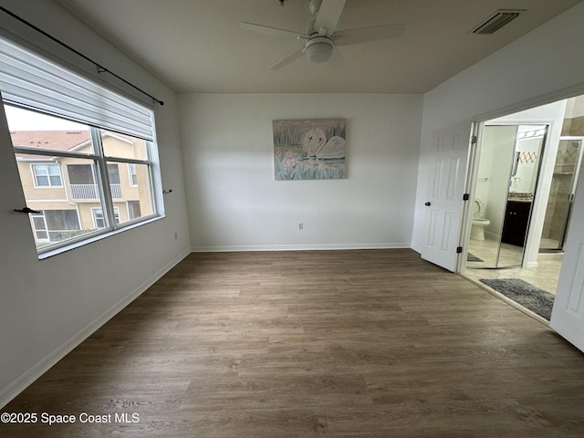 spare room featuring wood-type flooring and ceiling fan