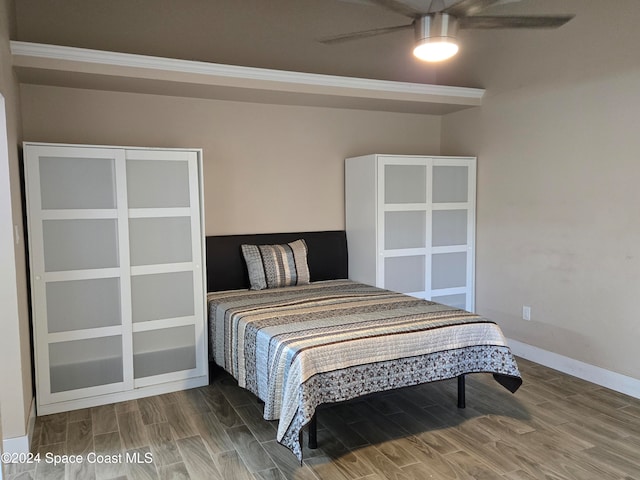 bedroom with hardwood / wood-style floors and ceiling fan