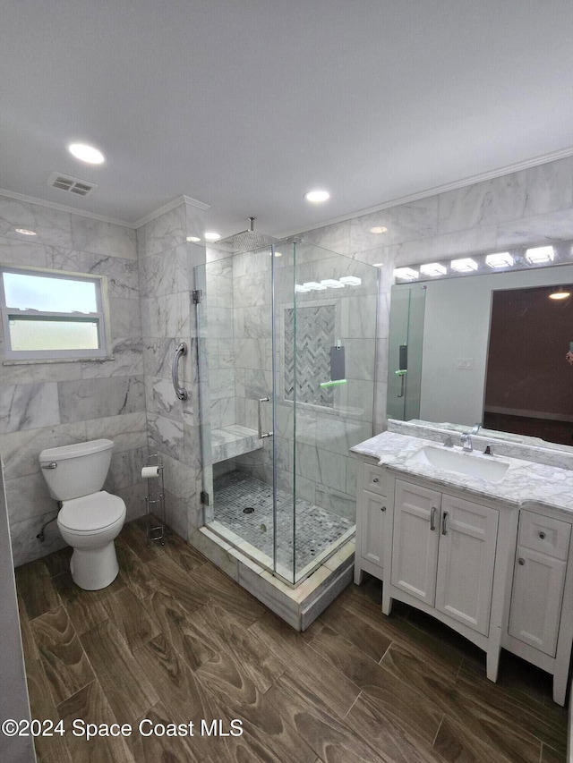 bathroom featuring walk in shower, tile walls, vanity, and toilet