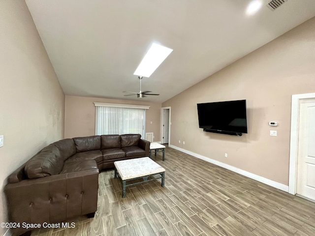 living room featuring ceiling fan, vaulted ceiling, and wood-type flooring