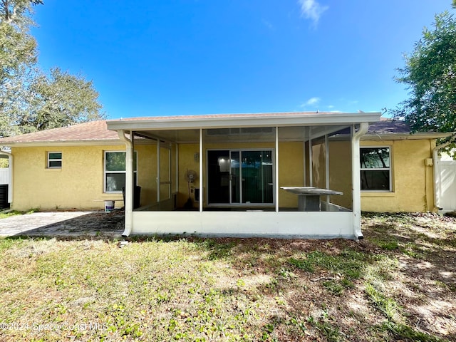 back of property featuring a sunroom