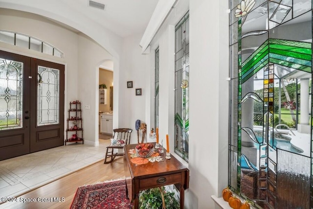 entrance foyer featuring hardwood / wood-style flooring and french doors