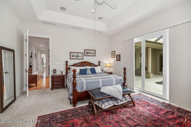 102 Wakefield Dr, Indian Harbour Beach, FL 32937 - bedroom featuring access to outside, light colored carpet, a ceiling fan, and a tray ceiling