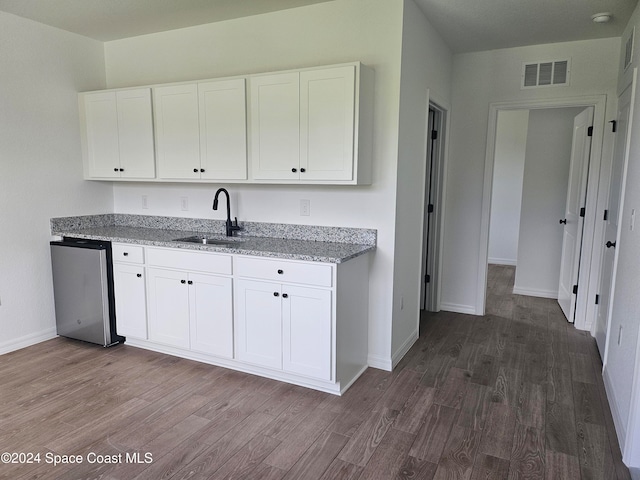 kitchen featuring white cabinetry, sink, and dark hardwood / wood-style flooring