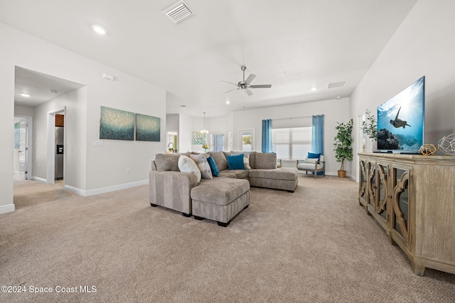 living room with ceiling fan with notable chandelier and light carpet