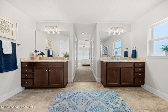 bathroom with plenty of natural light, vanity, and ceiling fan