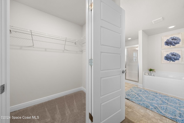 walk in closet with tile patterned floors