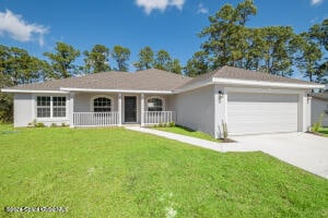 single story home with a front lawn and a garage