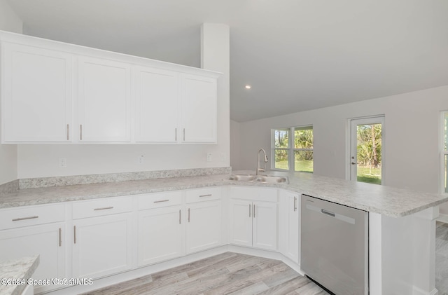 kitchen with white cabinetry, kitchen peninsula, sink, stainless steel dishwasher, and lofted ceiling