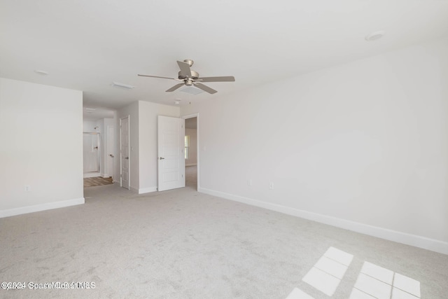 empty room with light colored carpet and ceiling fan