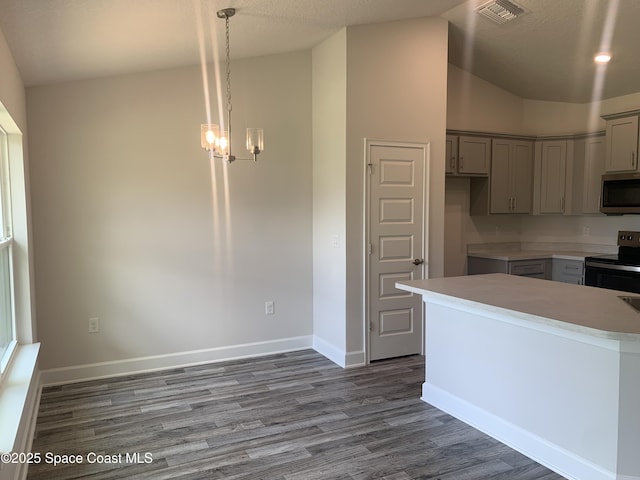 139 Whirl St SW, Palm Bay, FL 32908 - kitchen featuring appliances with stainless steel finishes, gray cabinetry, a chandelier, wood finished floors, and baseboards