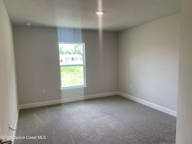 139 Whirl St SW, Palm Bay, FL 32908 - carpeted spare room with a textured ceiling, baseboards, and a smoke detector