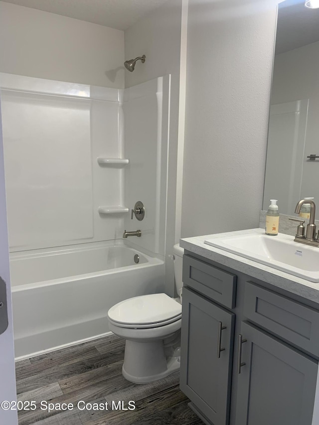 139 Whirl St SW, Palm Bay, FL 32908 - full bathroom with vanity, washtub / shower combination, toilet, and wood finished floors