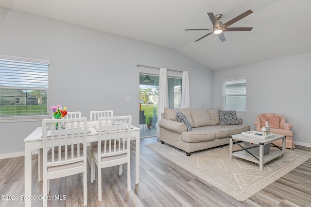 living room with ceiling fan, lofted ceiling, and hardwood / wood-style flooring