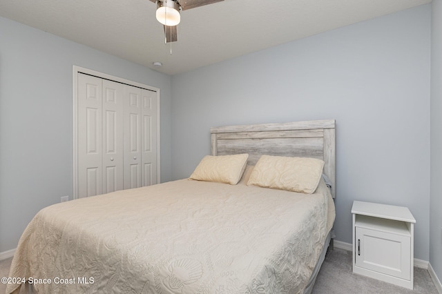 bedroom featuring ceiling fan, a closet, and carpet floors