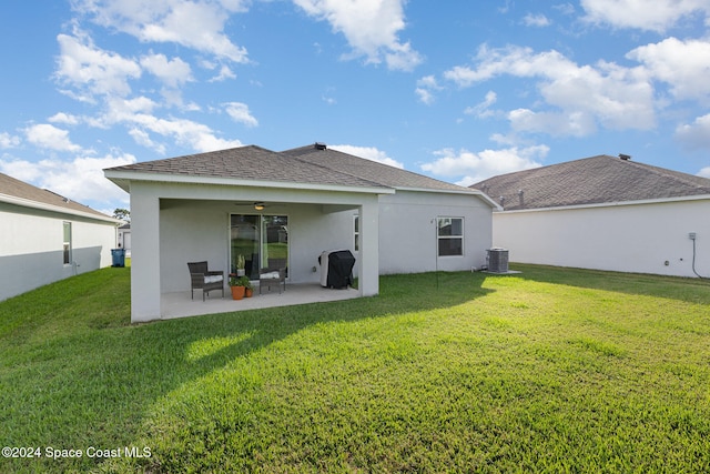 back of house with a patio area, ceiling fan, a yard, and central AC unit