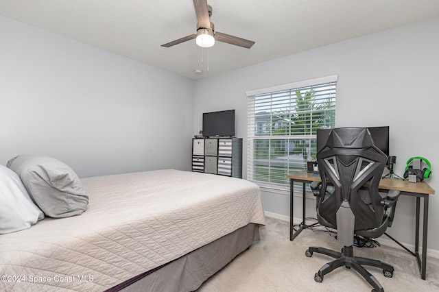 bedroom featuring ceiling fan and light carpet