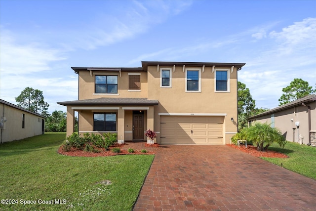 view of front of home featuring a garage and a front lawn