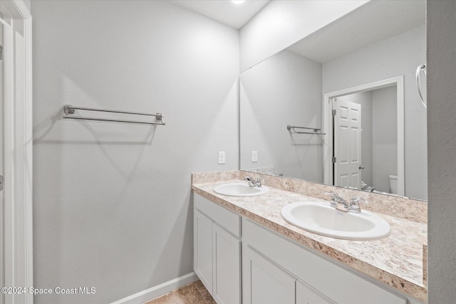 bathroom with vanity, tile patterned floors, and toilet