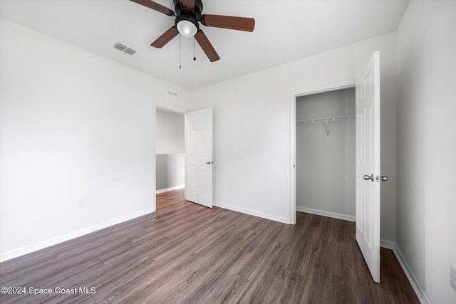 unfurnished bedroom with ceiling fan, a closet, and dark hardwood / wood-style flooring