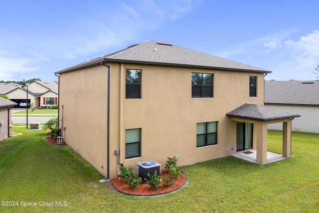 back of property featuring central AC unit, a patio, and a lawn