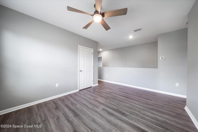 empty room with dark wood-type flooring and ceiling fan