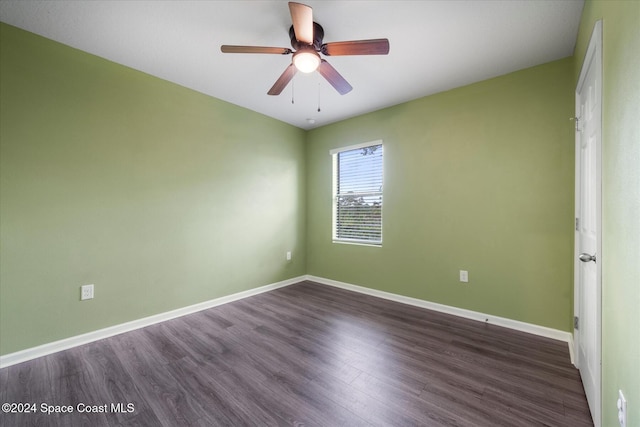 empty room with dark hardwood / wood-style floors and ceiling fan