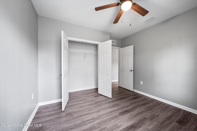 unfurnished bedroom featuring hardwood / wood-style flooring, ceiling fan, and a closet