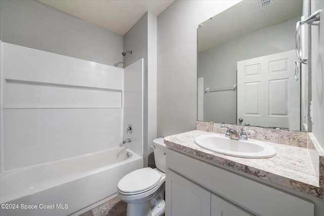 full bathroom with a textured ceiling, vanity, bathing tub / shower combination, and toilet