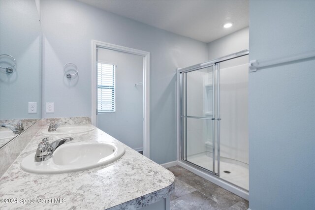 bathroom featuring vanity and a shower with shower door