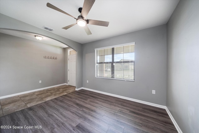 unfurnished room with ceiling fan and dark hardwood / wood-style floors