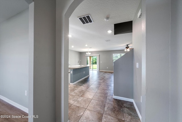 hall featuring sink and tile patterned flooring