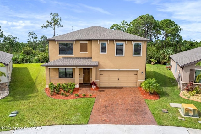 view of front facade with a garage and a front lawn