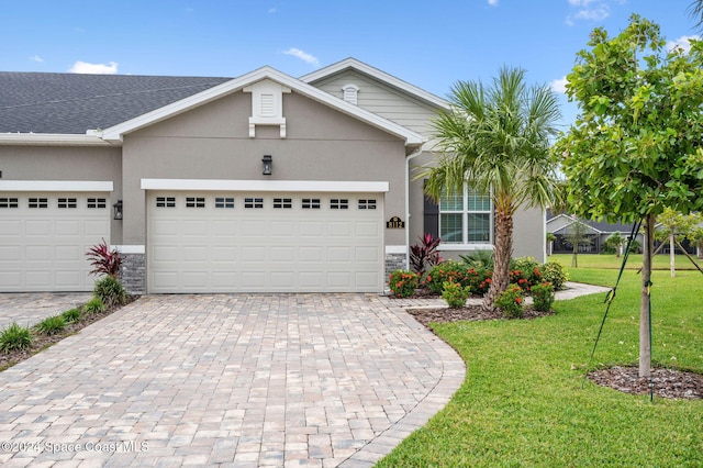 single story home featuring a garage and a front lawn