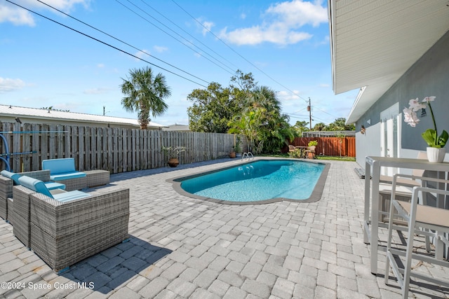 view of swimming pool with a patio