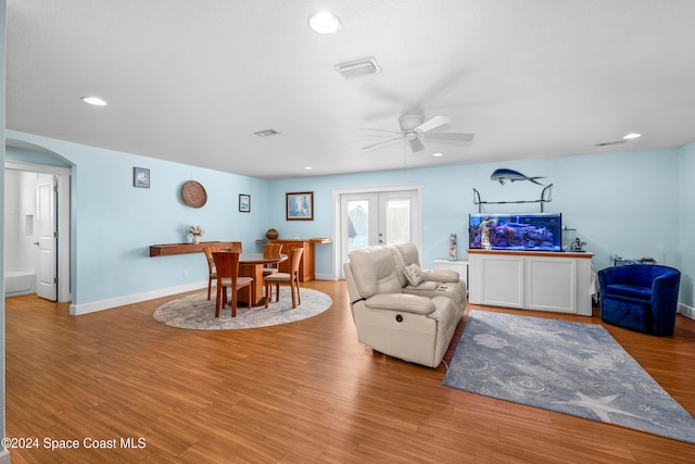 living room featuring french doors, light hardwood / wood-style floors, and ceiling fan