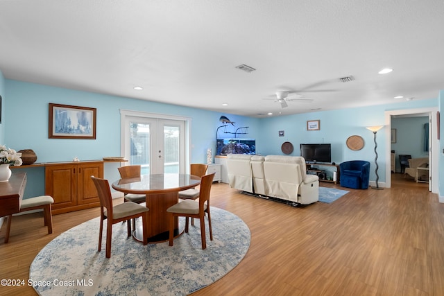 dining room featuring ceiling fan, light wood-type flooring, and french doors