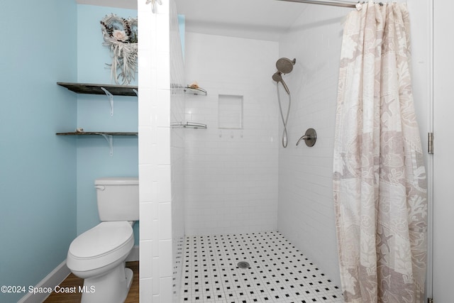 bathroom featuring hardwood / wood-style flooring, a shower with curtain, and toilet