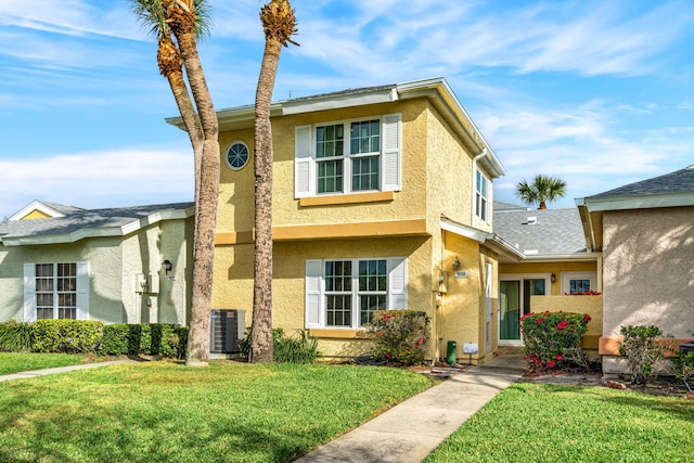 view of front facade with a front lawn and central AC unit