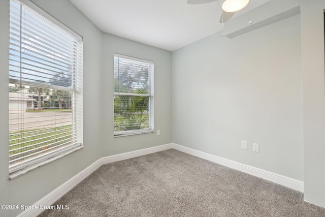 spare room with carpet floors and ceiling fan