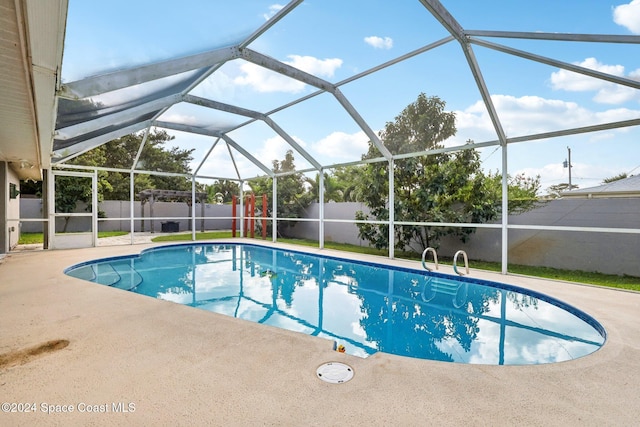 view of pool featuring a lanai and a patio area