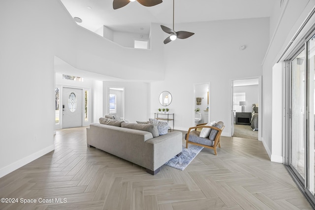 living room featuring ceiling fan, high vaulted ceiling, and a healthy amount of sunlight