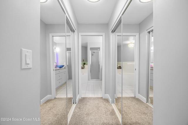 bathroom with tile patterned flooring, vanity, and a shower with door