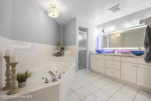 bathroom featuring tile patterned flooring, vanity, and shower with separate bathtub