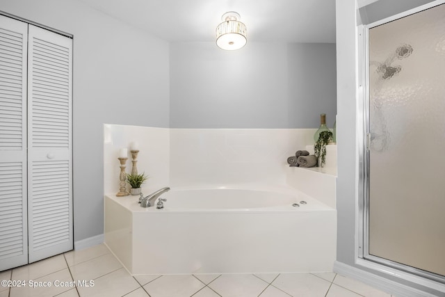 bathroom with tile patterned flooring and separate shower and tub