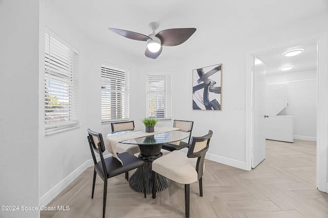 dining area with light parquet floors and ceiling fan