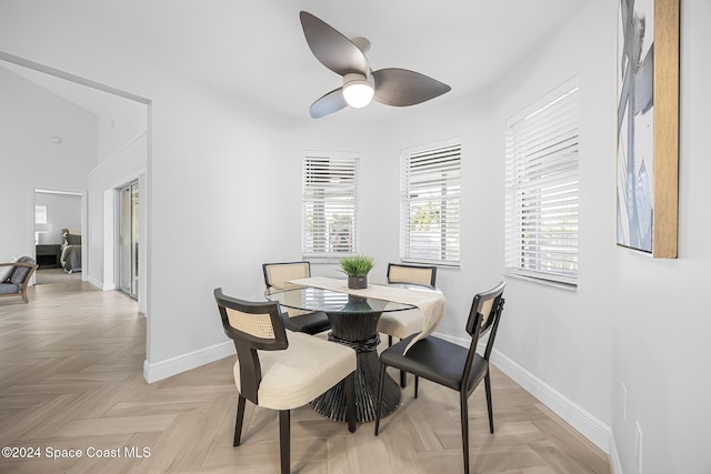 dining room with light parquet flooring and ceiling fan