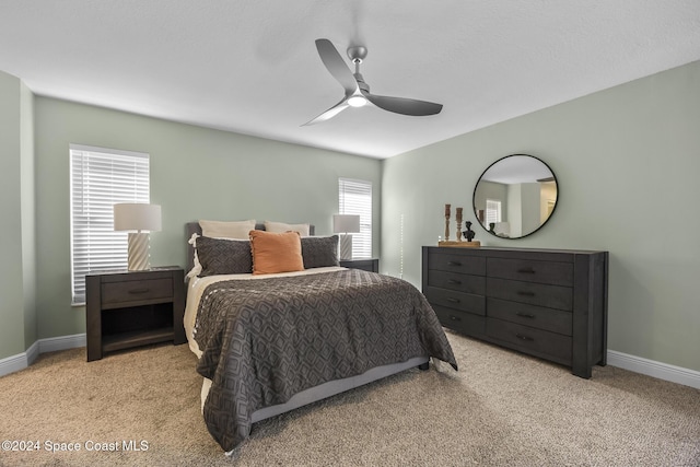 bedroom featuring ceiling fan and light colored carpet