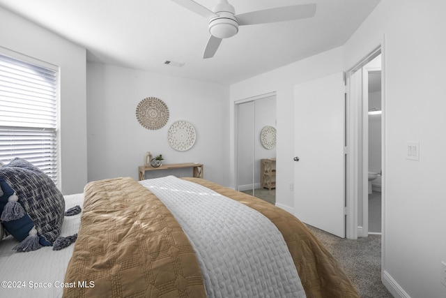 carpeted bedroom featuring ceiling fan and a closet