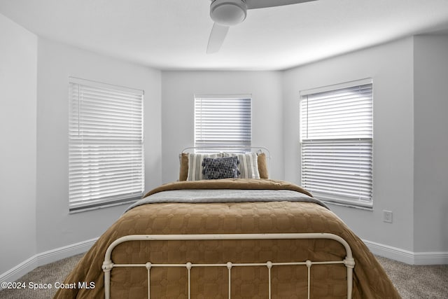 bedroom with carpet, multiple windows, and ceiling fan